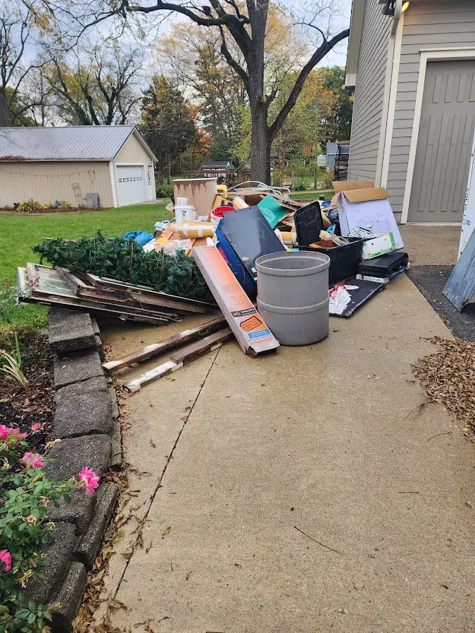 Dumpster being loaded with debris for 12 Yard Dumpster Rental in Malvern
